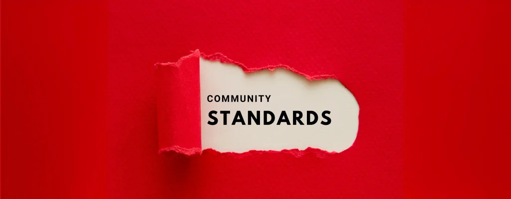 A tearing paper with text “community standards”