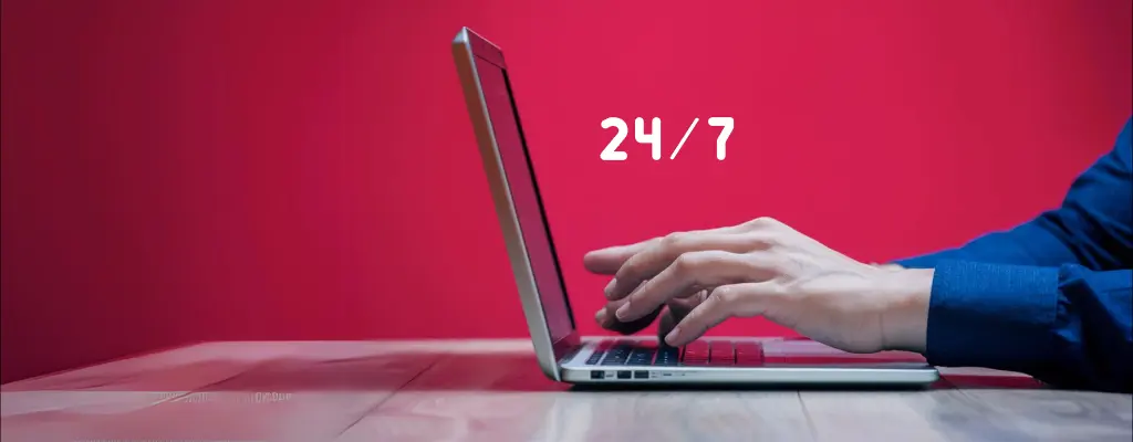 A customer service agent typing in a laptop with text “24/7”
