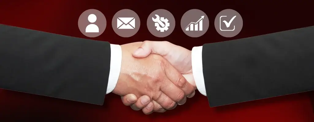 A handshake between two individuals with business icons around them